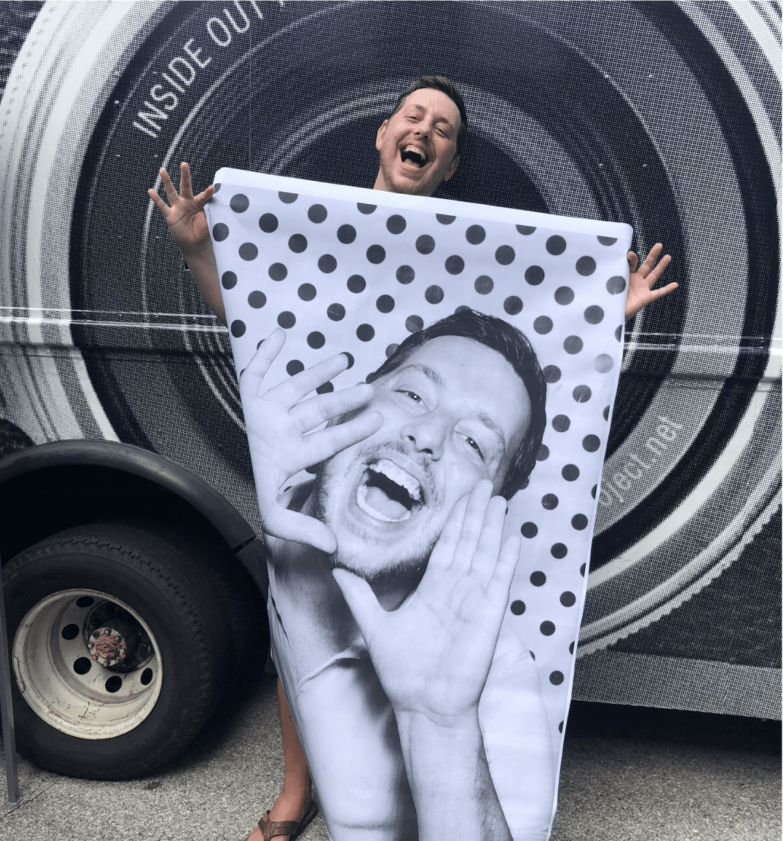 Michael States holding a large-format photo print, smiling