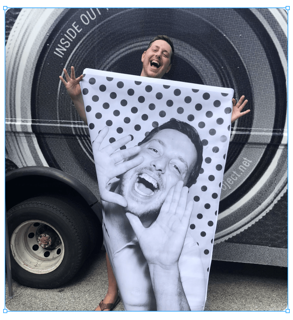 Michael States holding a large-format photo print, smiling